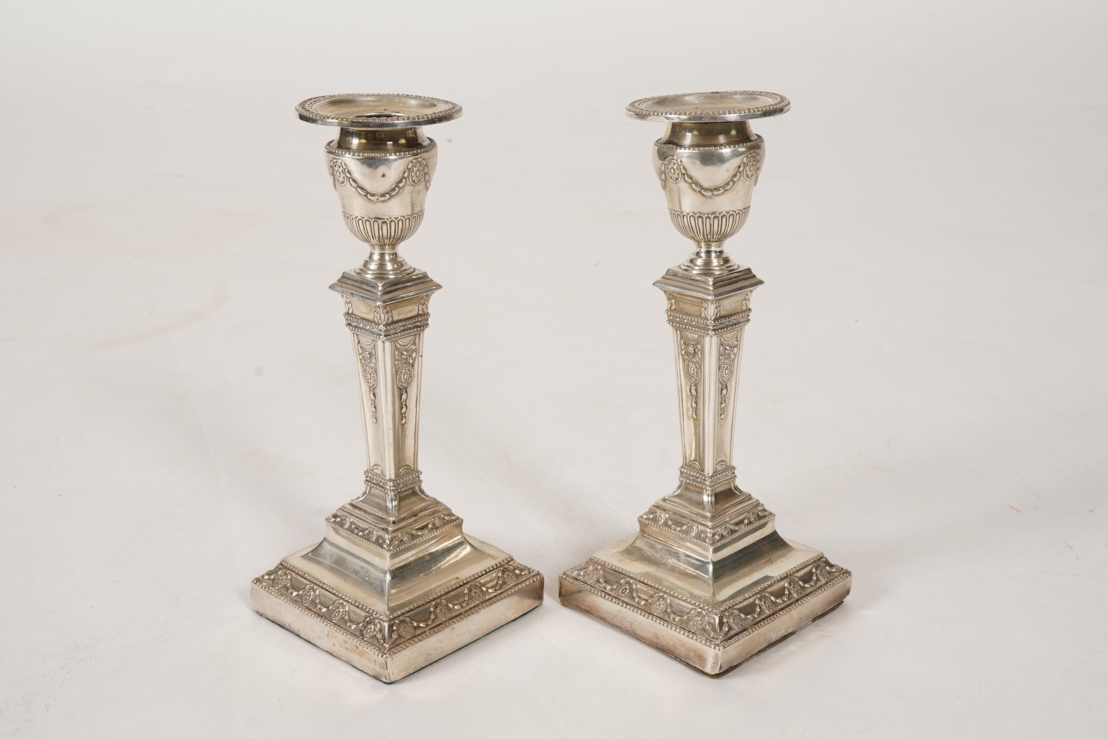 A pair of Victorian silver candlesticks, with fixed sconces, by Henry Wilkinson & Co